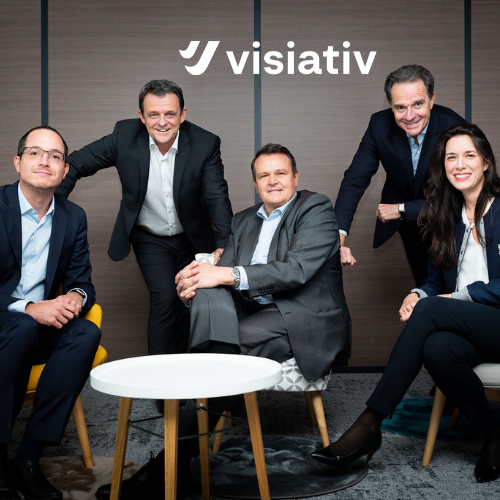 Group of People in an Office Setting With the Visitiav Logo In the Background